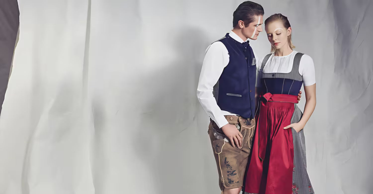 Two people wearing traditional outfits against a plain background